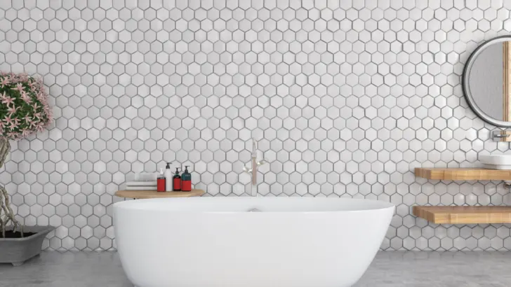 White hexagon tile bathroom complemented with grey.