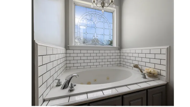 Add a touch of glamour to your soak with a stunning chandelier over your bath tub.